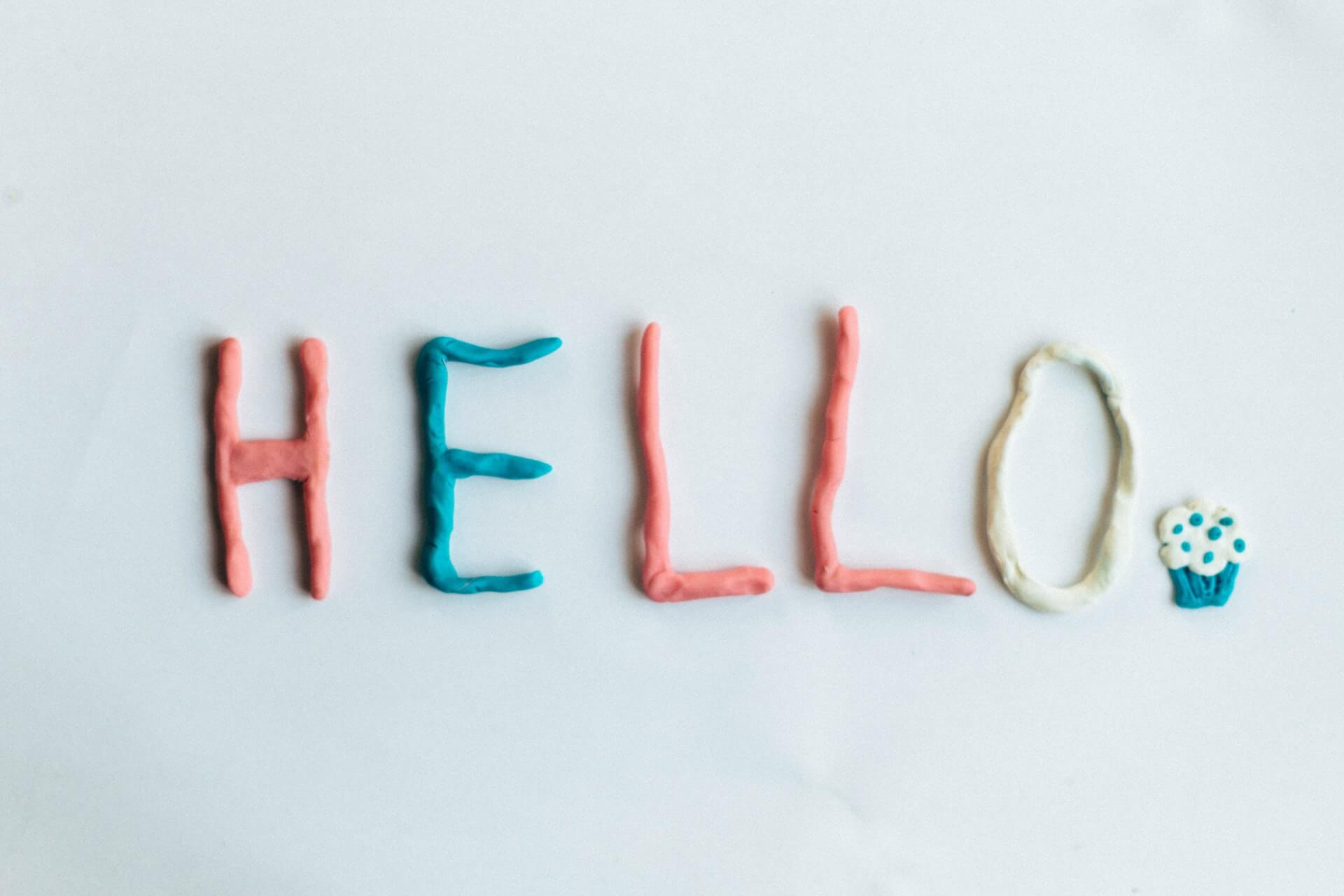The word "hello" is written with colored clay