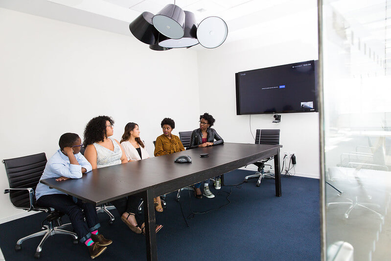in a boardroom, 5 women of color discuss tech enhancements