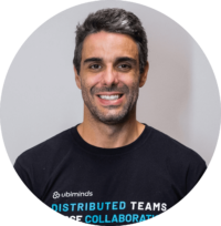 Paulo is a middle-aged man with greyish hair. He's wearing a black t-shirt that reads "distributed teams, close collanoration"